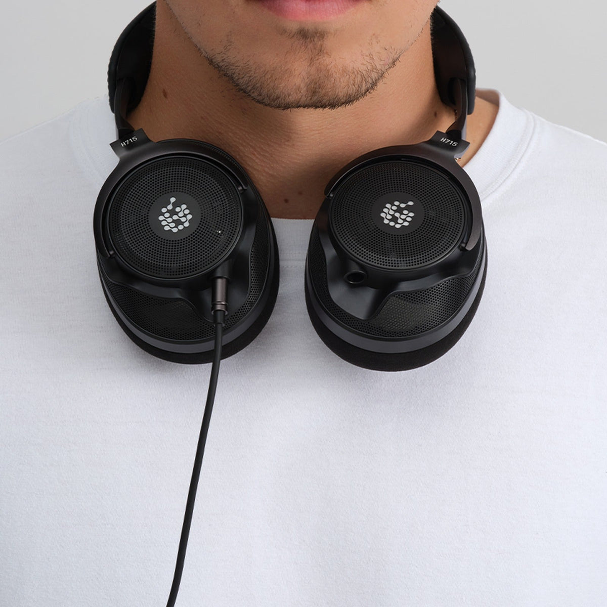 Adam Audio H715 Reference headphones worn around the neck